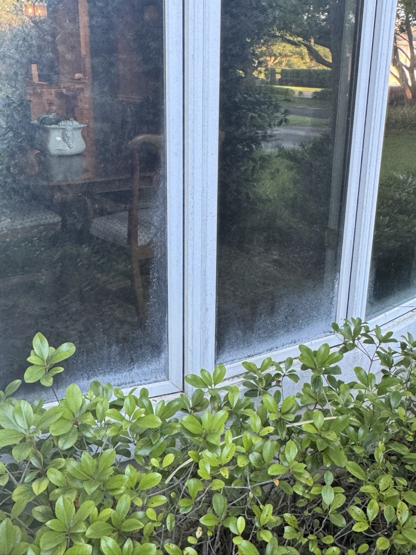 Before: St. Simons Island bay window covered in hard water and salt film