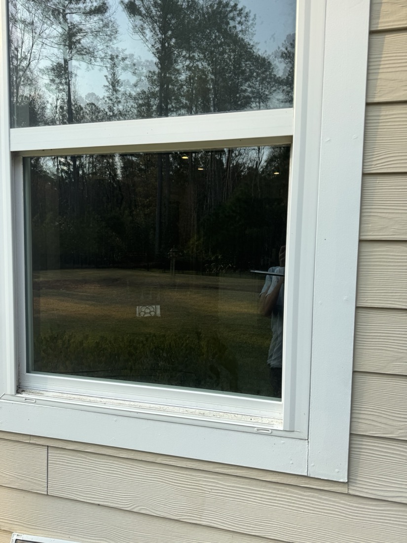 After: the same window cleaned streak-free, with frame and sill wiped down